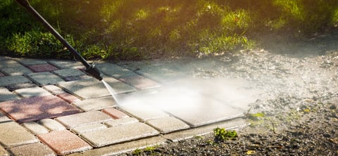 Dirty block pavement being cleaned