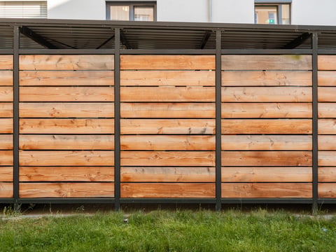 Wooden planks on carport wall with green grass