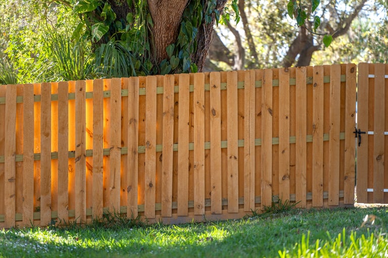 Wooden plank fence in backyard for privacy and protection