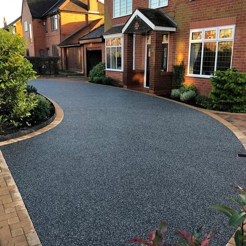 Modern residential driveway with dark permeable paving