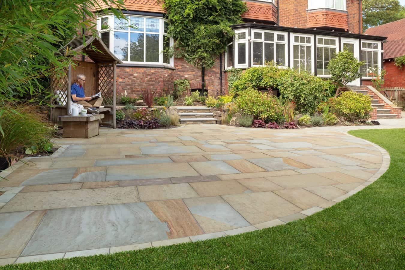 Garden design with stone patio and lawn